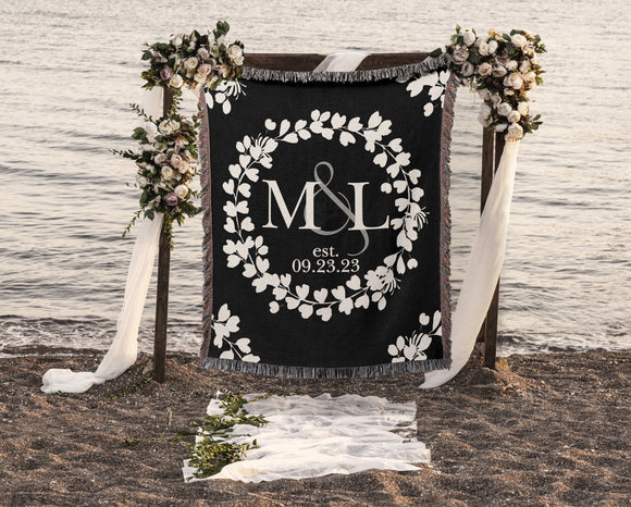 Soft Natural White floral wreath on black background with couple's monogram initials adorn this beautiful woven cotton throw. Includes established date underneath custom monogram initials.