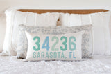 Multi colored coastal blue colors adorn this personalized zip code and city, state pillow. Available in multiple background colors. Made in the USA