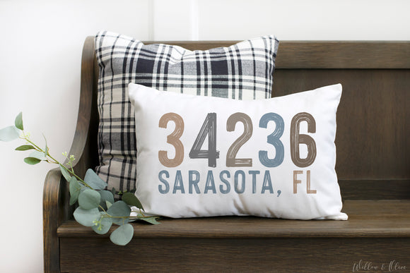 Multi colored coastal neutral colors adorn this personalized zip code and city, state pillow. Available in multiple background colors. Made in the USA