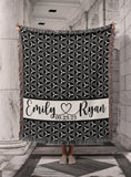 Personalized Woven Cotton Wedding Anniversary Throw Blanket, with soft white and black geometric design. Personalized with script style font first names separated with heart and established date. Made in the USA