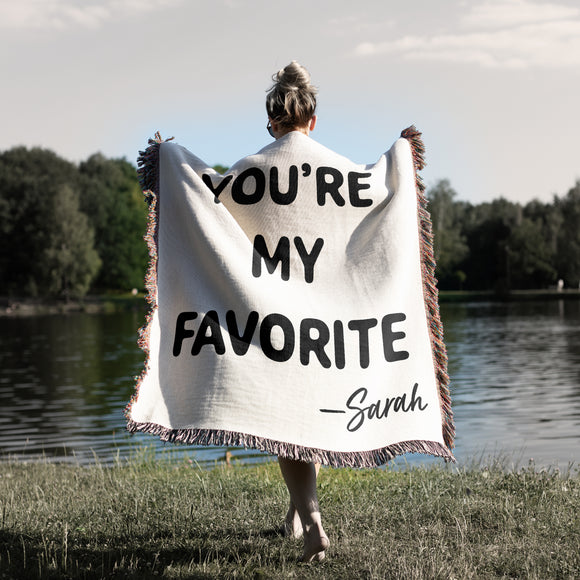 You're My Favorite phrase in bold black letters on soft natural white woven cotton throw. Personalized with your To and From First Names.  Made in the USA
